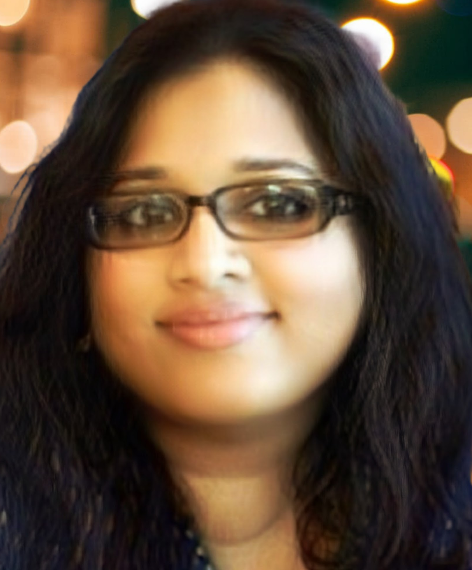 Headshot of Reena Joseph - a female with long black hair and glasses