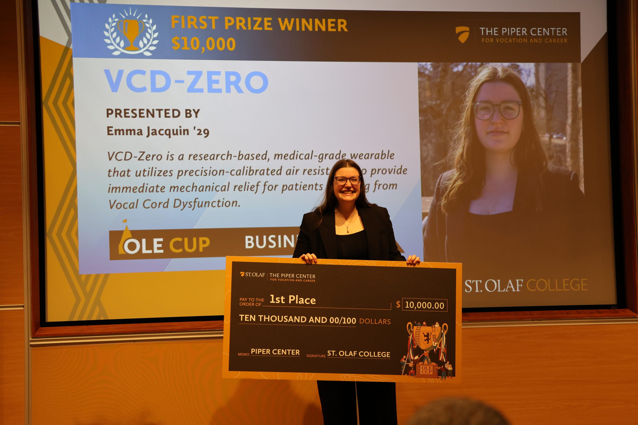 VCD-Zero holding the 10,000 dollar check for winning first place